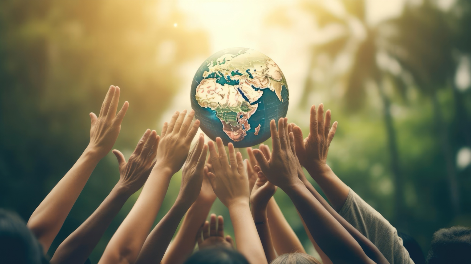 Many hands reaching up together for a globe — one community, built across borders